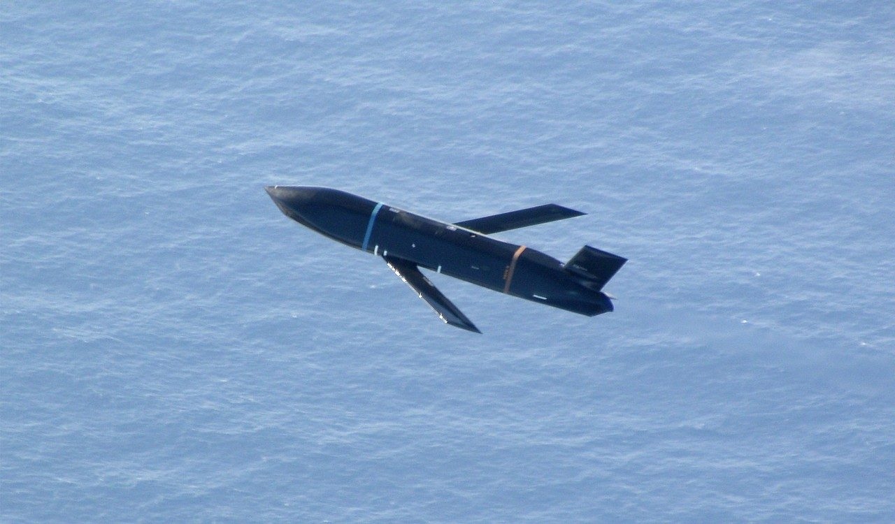 Missile in flight over ocean — naval defense application